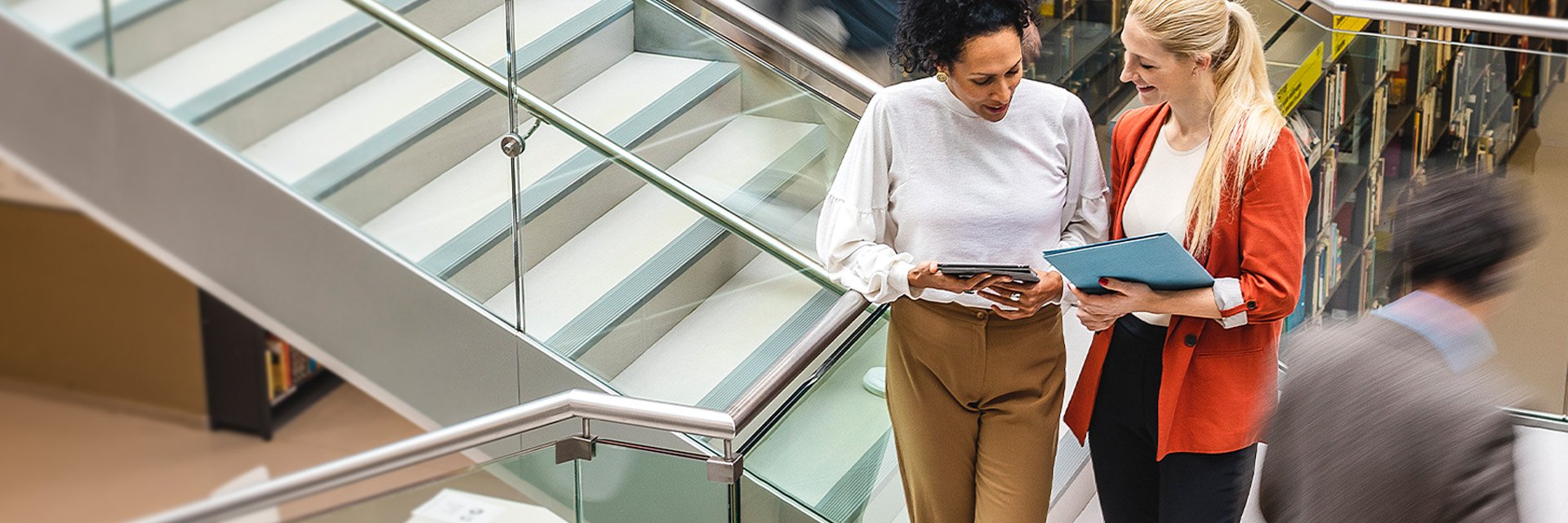 two-women-on-tablet-stairs
