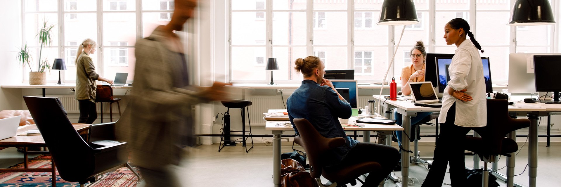 coworkers-talking-at-office-desk
