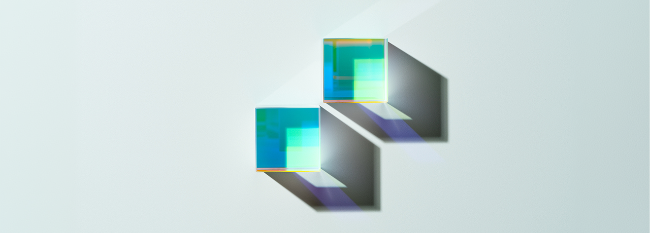 two glass cubes on a pale blue background
