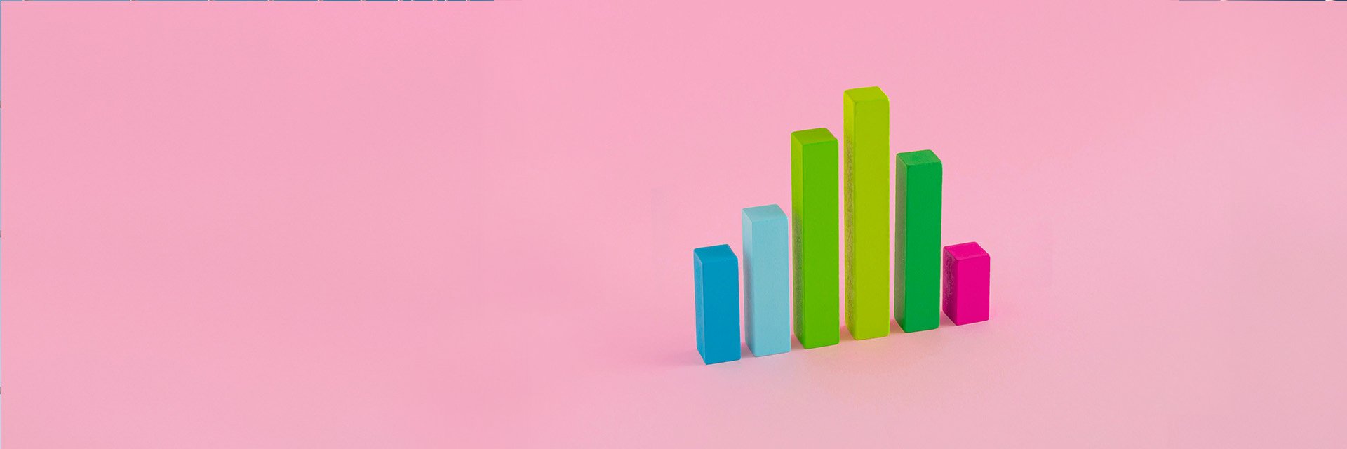 colorful blocks forming the shape of an increasing bar chart on a pink background
