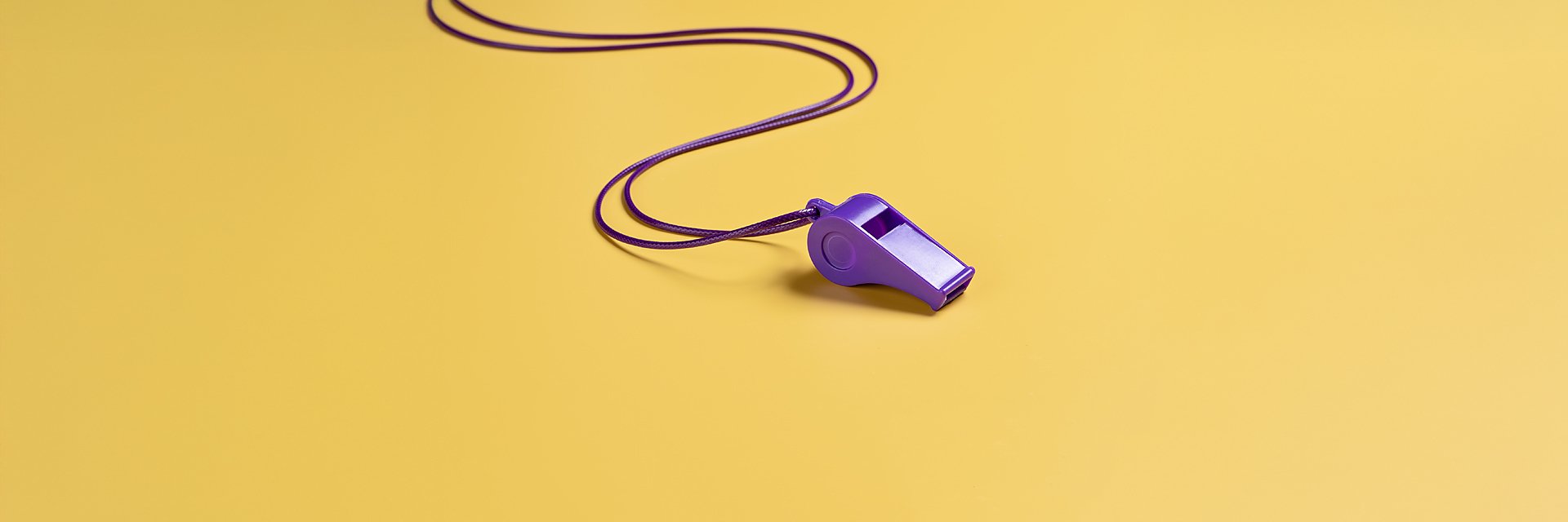 a purple whistle on a yellow background