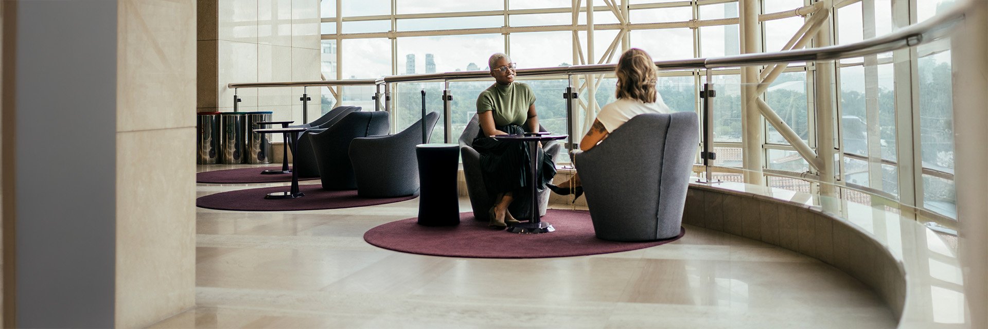 two-people-sitting-talking-by-windows