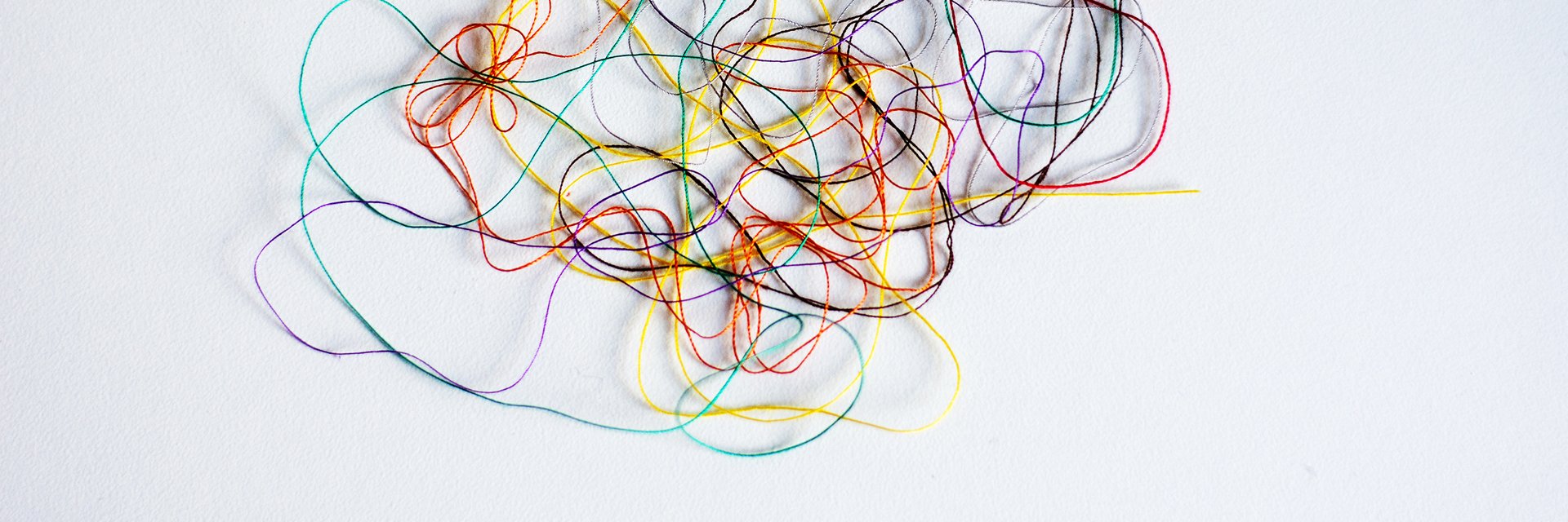 Colored tangled thread on a white background