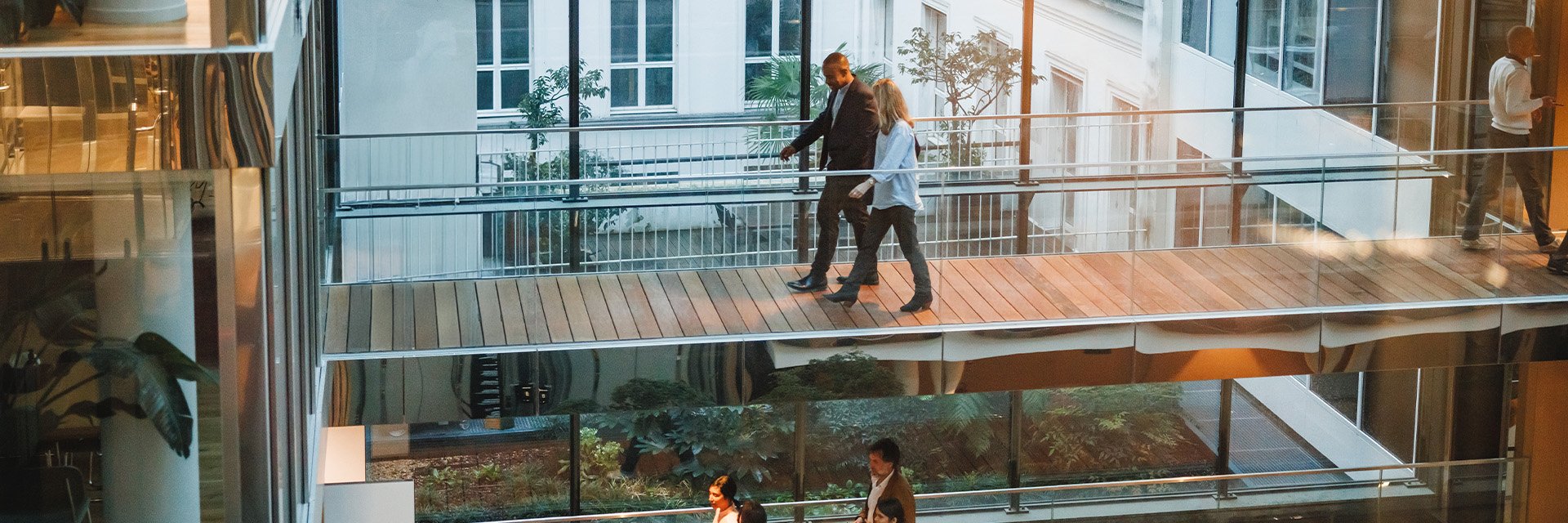 people-walking-on-glass-balcony-office