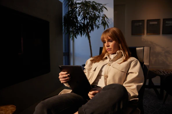 woman with tablet reading about solar panels in the winter