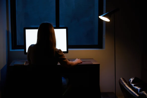 woman using computer at night