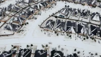 21_Robert S_ Aerial view of snowy neighborhood and panels_Southwest_TX