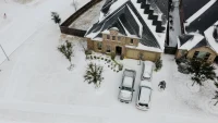 21_Robert S_ Aerial view of snowy house and panels_Southwest_TX
