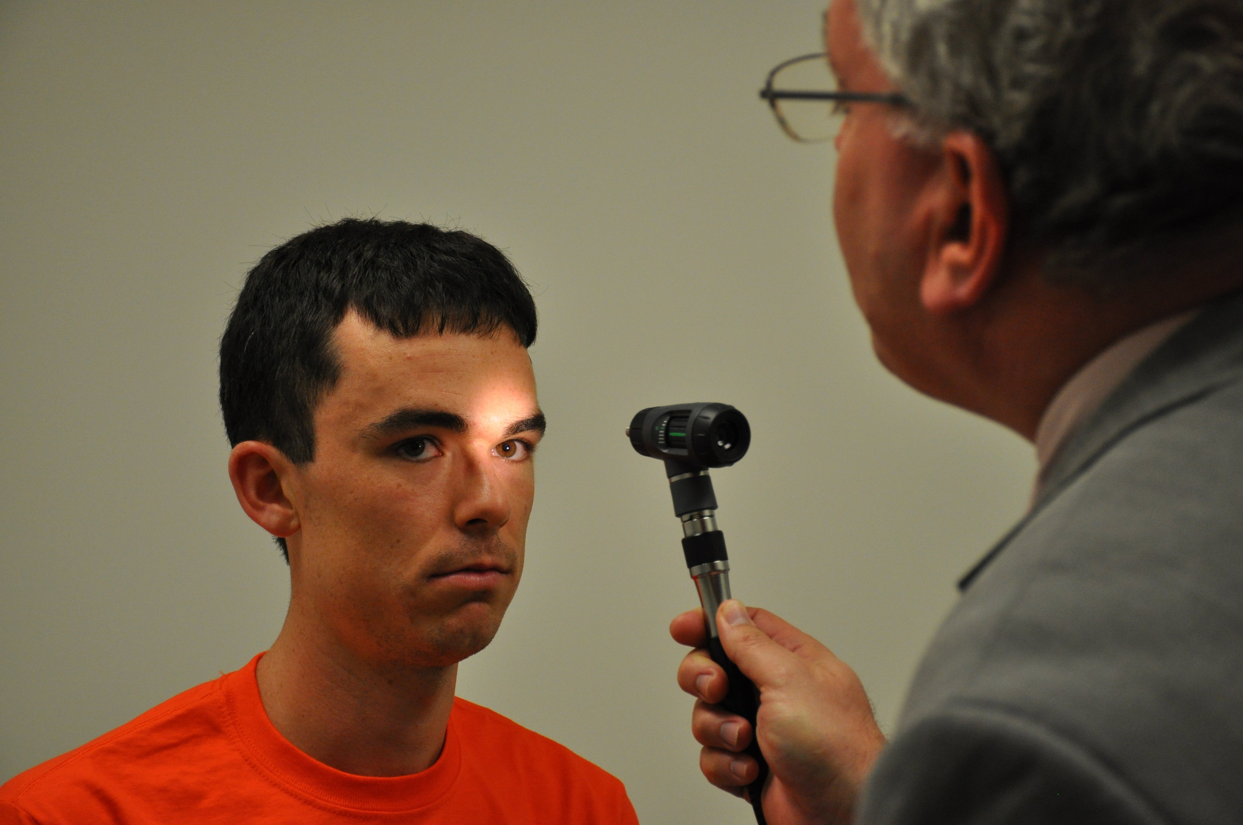 A Mini-Medical School participant practices the cranial nerve exam on a medical student volunteer.