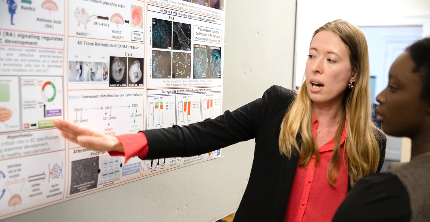two students discussing scientific poster at Graduatte Biosciences Society 2023 Symposium.