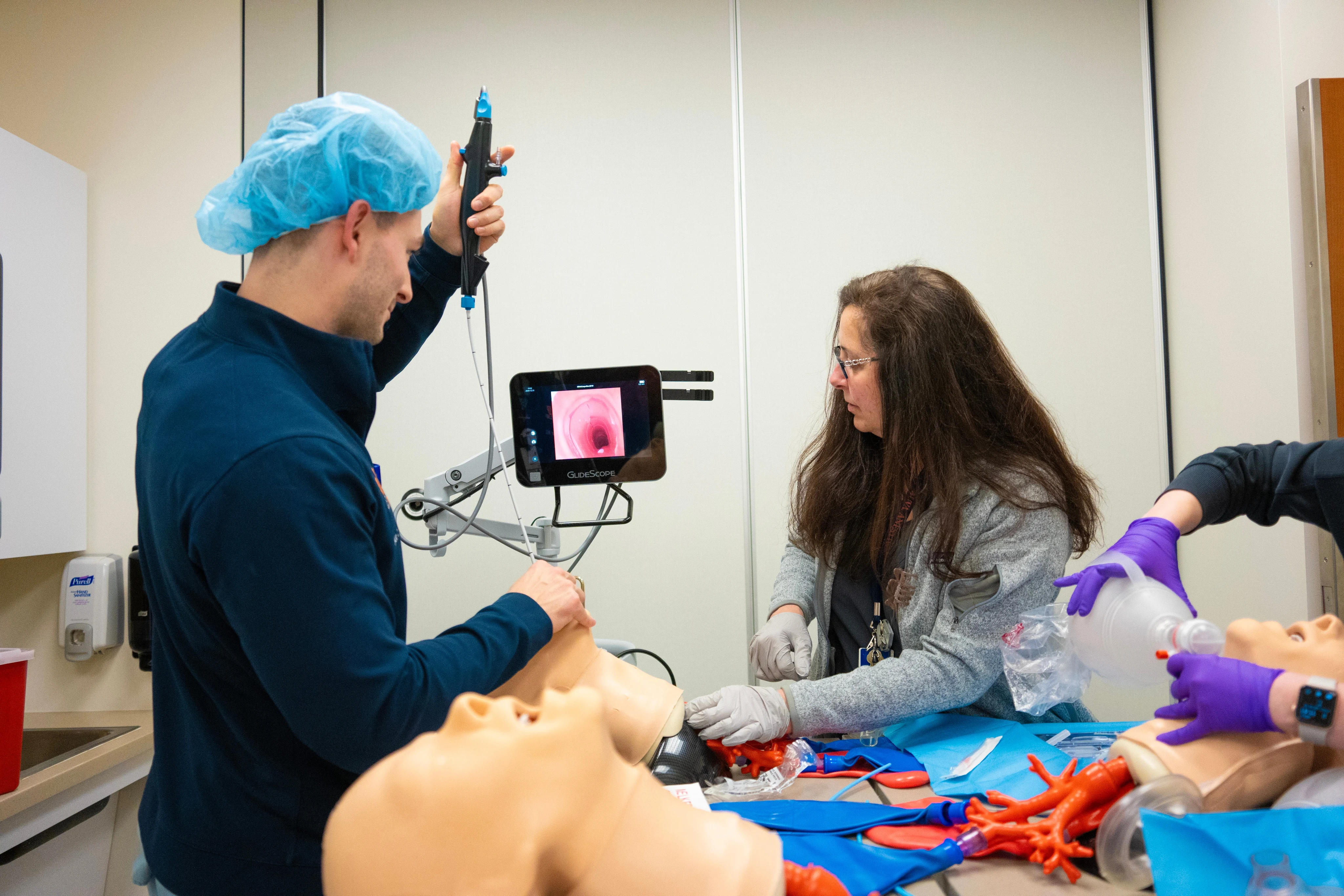 A University of Virginia Anesthesiology doctor teaches residents how to place a line in on mannequins at the Medical Simulation Center. 
