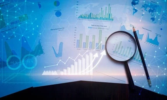 Conceptual illustration depicting a composite of charts and graphs overlayed with a magnifying glass and pencil
