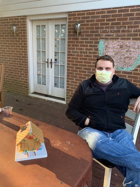 Resident Chris building a gingerbread house