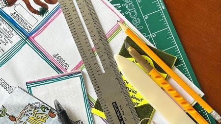ruler, cutting mat, pencil and other zine-making supplies