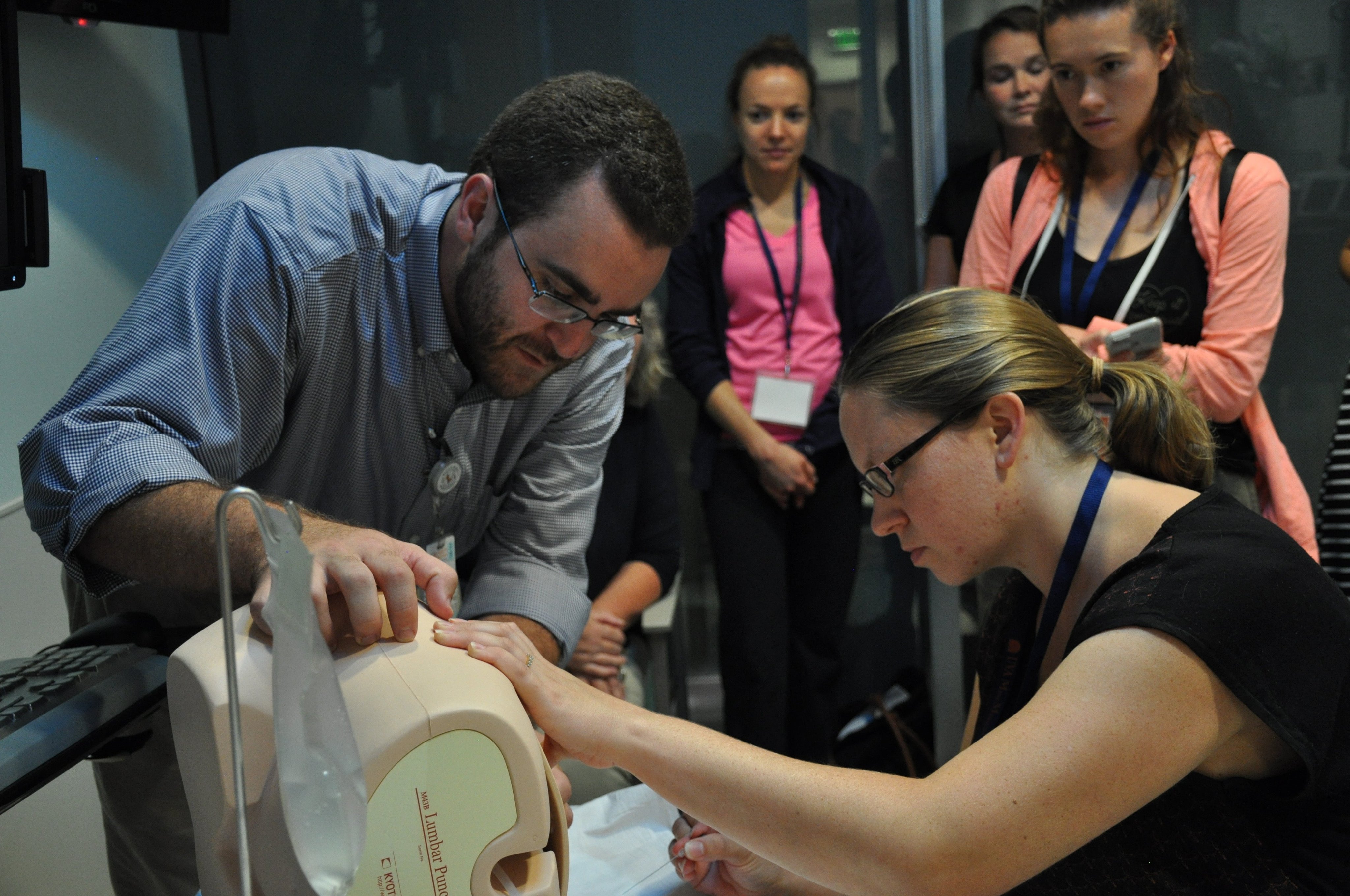 Mini-Medical School participants try their hands at administering pediatric lumbar punctures.