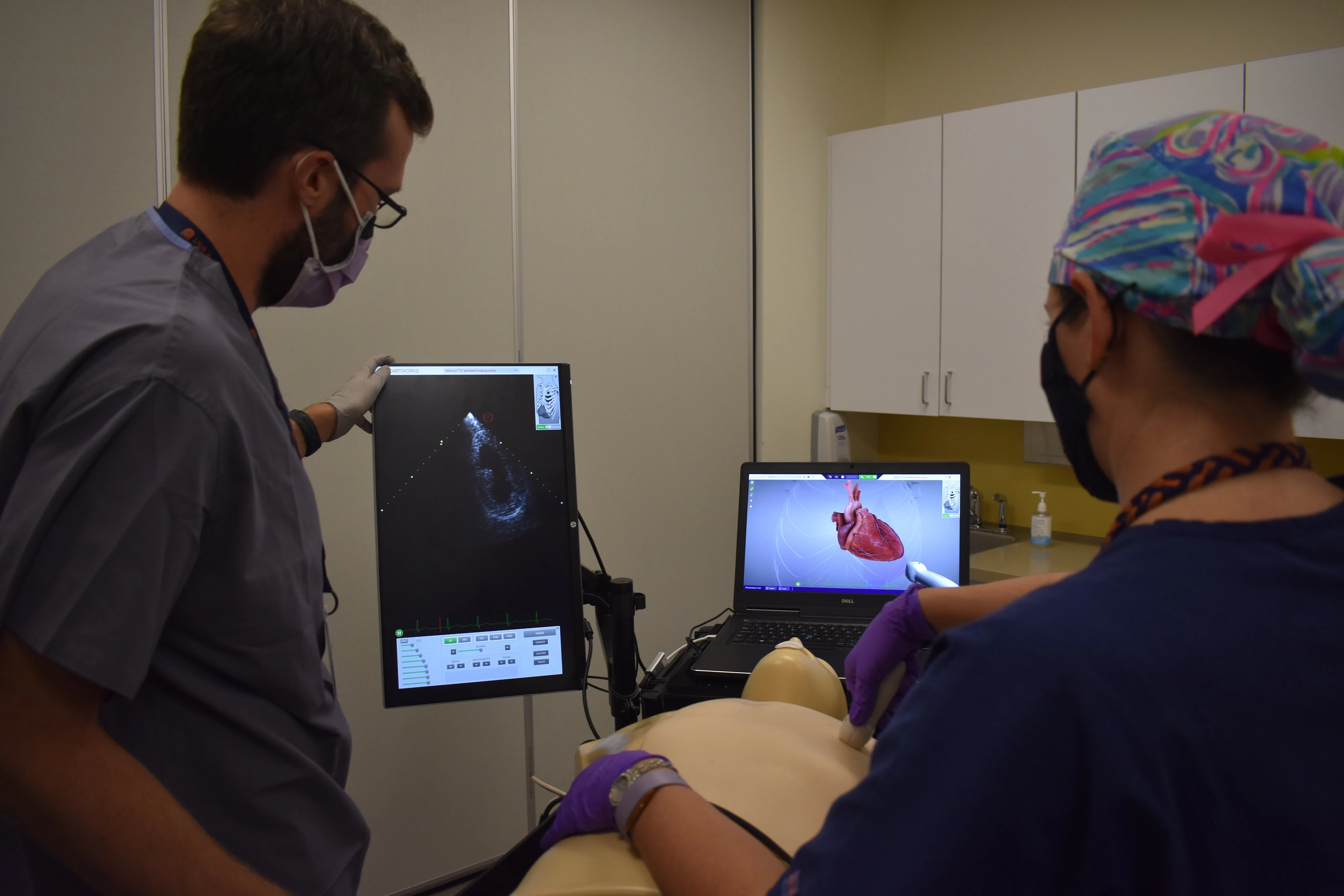 University of Virginia Anesthesiology Doctor teaches a resident as they view a screen in the Medical Simulation Center.